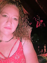 a woman in a red dress is posing for a photo